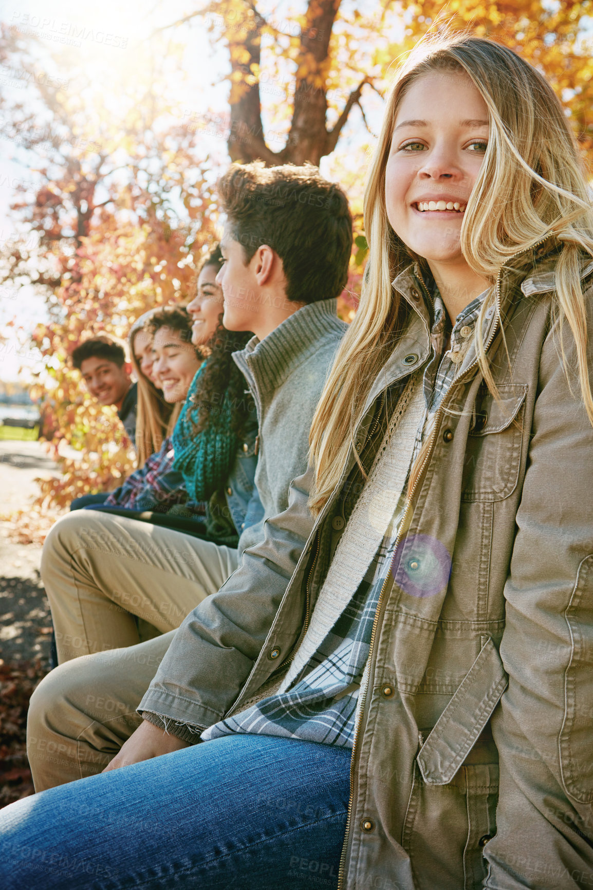 Buy stock photo Nature, portrait and group of teenagers on vacation, adventure or weekend trip together in Autumn. Smile, travel and young friends on holiday sitting in outdoor garden, park or field in New Zealand.