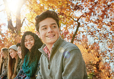 Buy stock photo Shot of a group of young friends enjoying a day at the park together