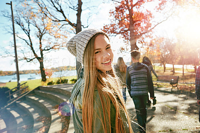 Buy stock photo Teenager, girl in nature with friends and walk in park with autumn and sunshine, wellness with happy in portrait. Youth outdoor, enjoy fresh air and bonding with smile, flare with adventure or travel