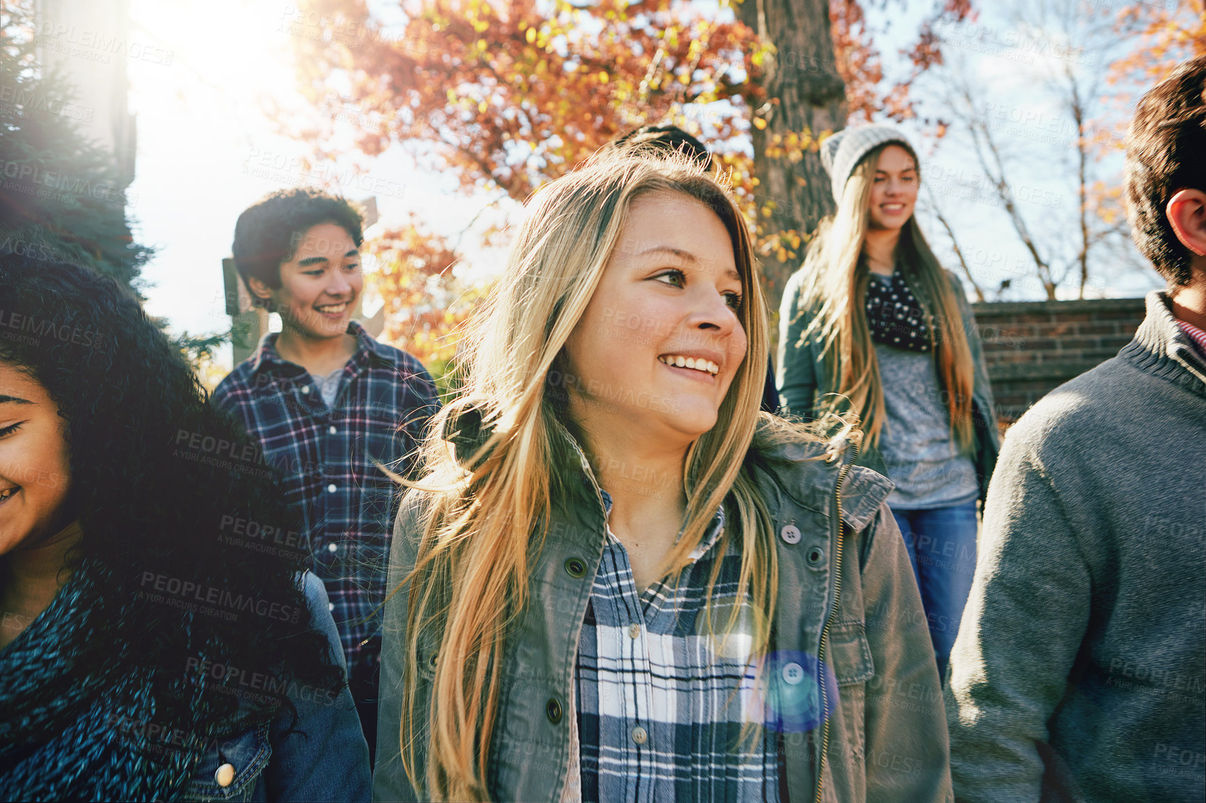 Buy stock photo Walking, teenager and talking with friends in park, nature or social group outdoor together with diversity. Happy, teens or kids relax in fall with a joke, best friend or conversation in community