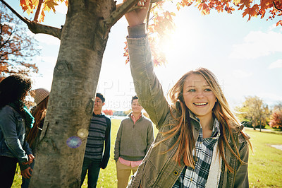 Buy stock photo Shot of a group of teenage friends enjoying an autumn day outside together