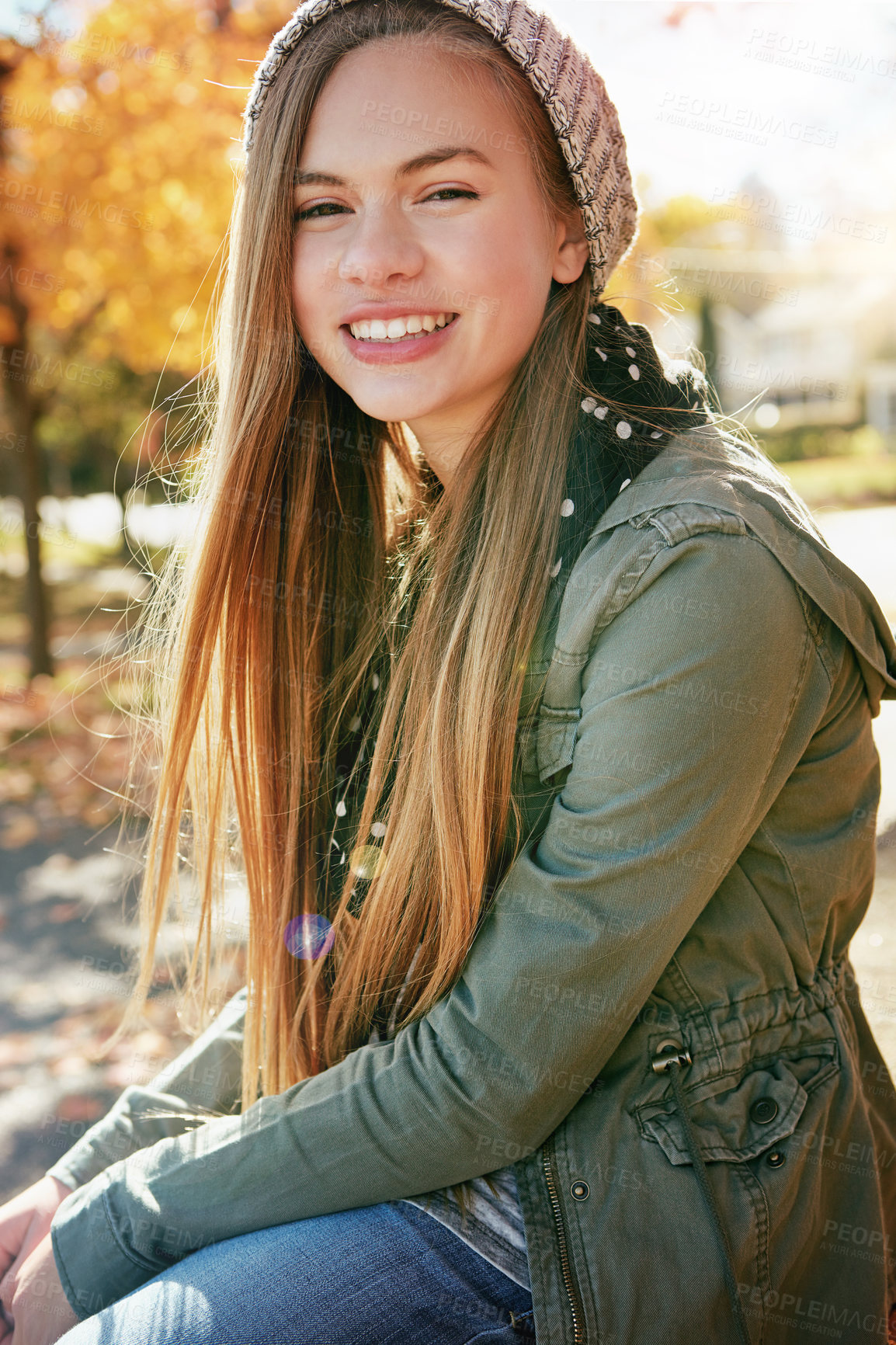 Buy stock photo Portrait of a happy teenage girl enjoying an autumn day in the park