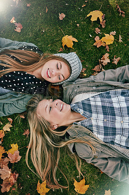 Buy stock photo Above, friends or girls on park for lying, relaxing and bonding together on grass with happiness. Nature, lawn and teenagers on summer holiday for chilling, hanging out and laugh outdoors with smile