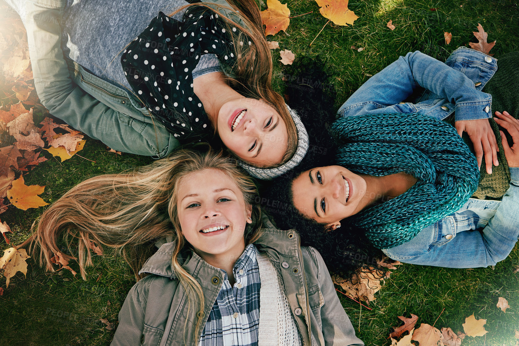 Buy stock photo Above, girls and portrait on grass for autumn, relaxing and bonding together in park with happiness. Nature, lawn and friends on summer holiday for chilling, hanging out and laugh outdoors with smile