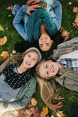 Buy stock photo Above, friends or portrait on grass for lying, relaxing and bonding together in park with happiness. Nature, girls and teens on summer holiday for chilling, hanging out and laugh outdoors with smile