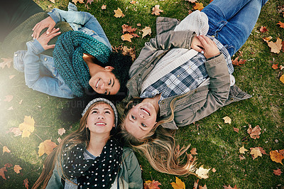 Buy stock photo Top view, teen girls on grass for lying, relaxing and bonding together in park with happiness. Nature, lawn and friends on summer holiday for chilling, hanging out and laugh outdoors with smile