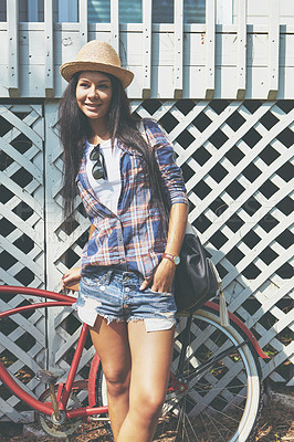 Buy stock photo Shot of a beautiful young woman riding her bike in the park