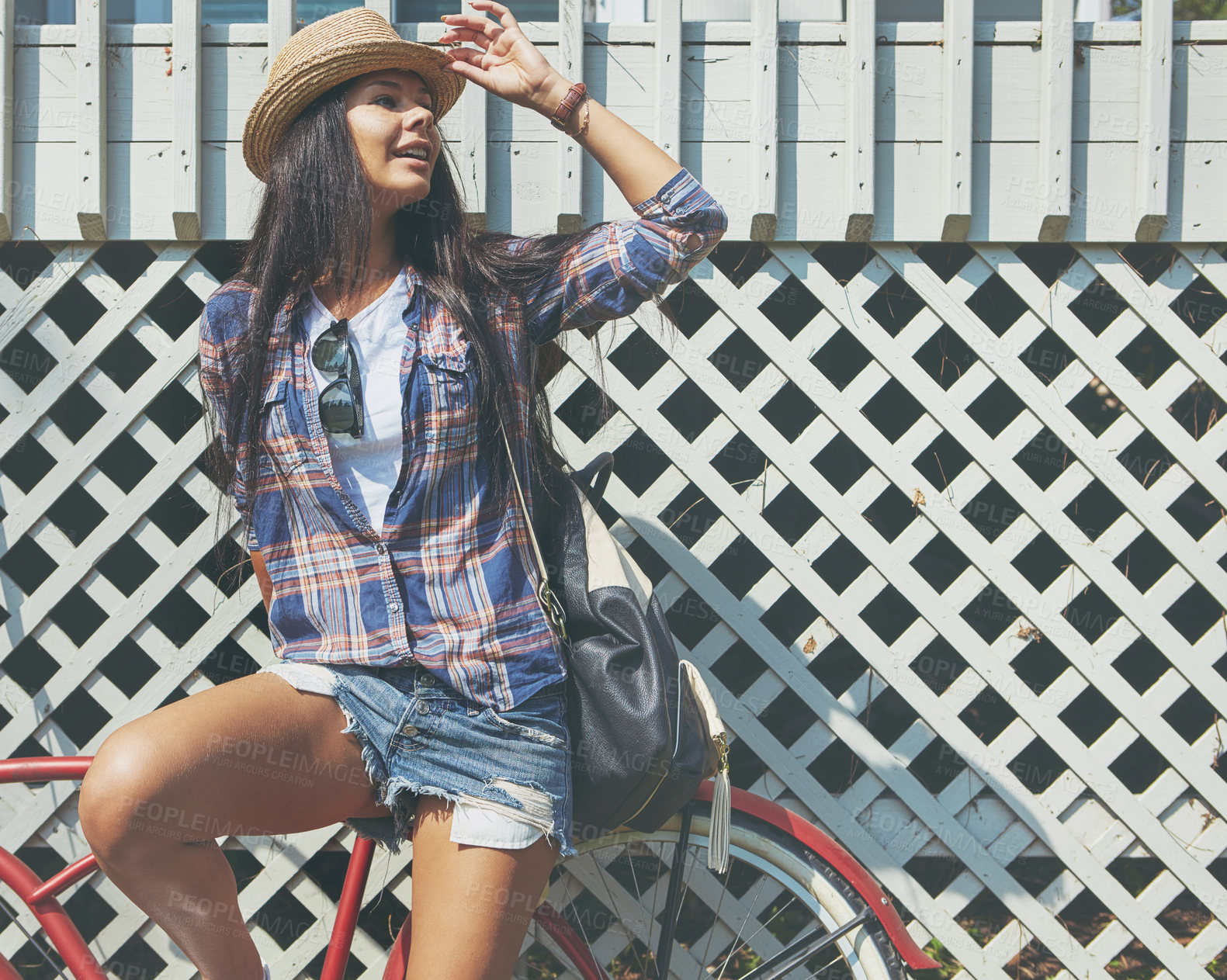 Buy stock photo Shot of a beautiful young woman riding her bike in the park