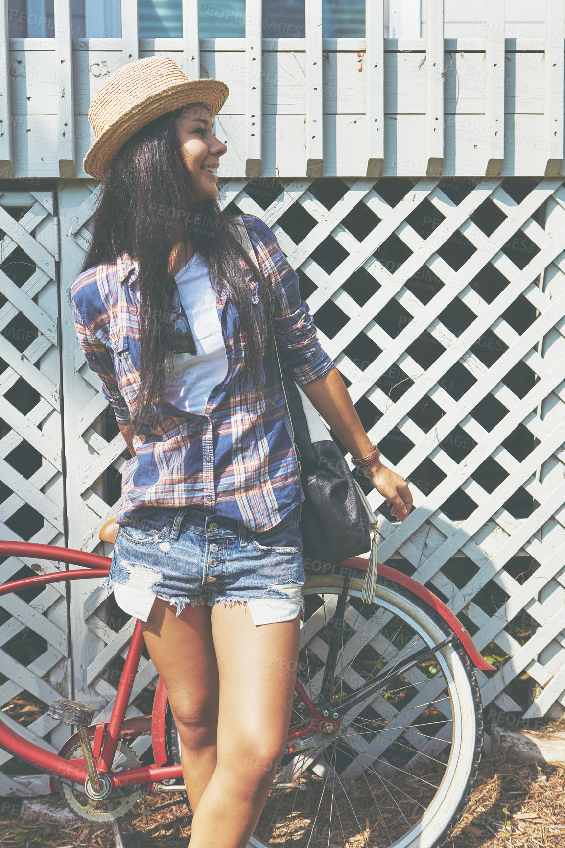 Buy stock photo Shot of a beautiful young woman riding her bike in the park