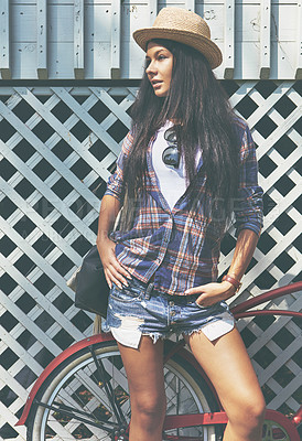 Buy stock photo Shot of a beautiful young woman riding her bike in the park