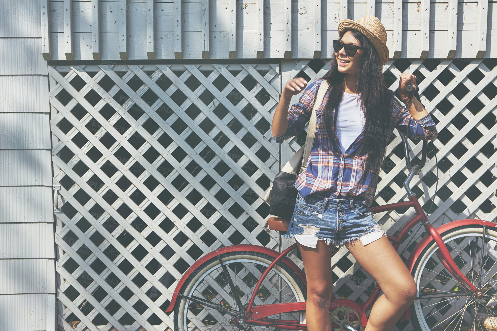 Buy stock photo Shot of a beautiful young woman riding her bike in the park