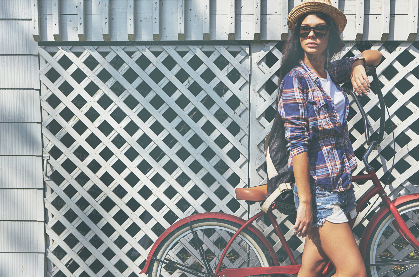 Buy stock photo Shot of a beautiful young woman riding her bike in the park