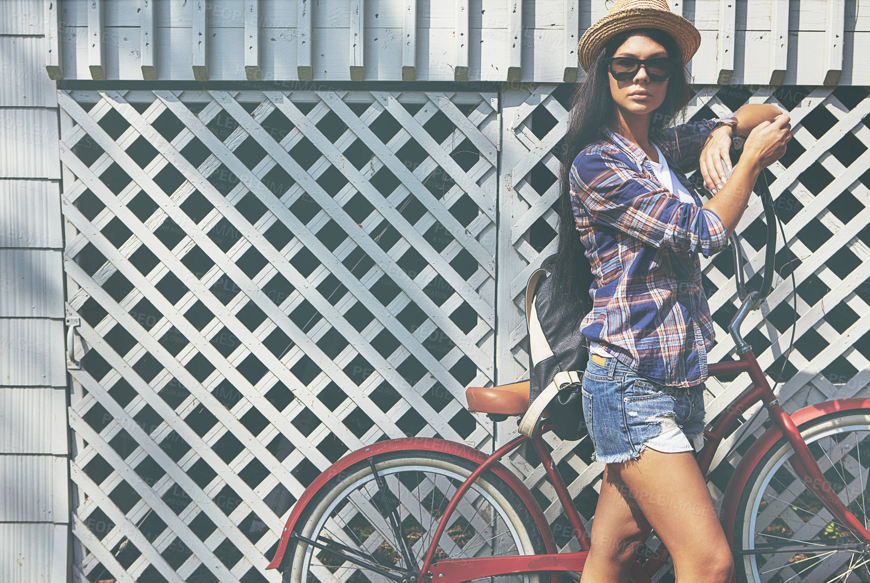 Buy stock photo Portrait of a beautiful young woman riding her bike in the park