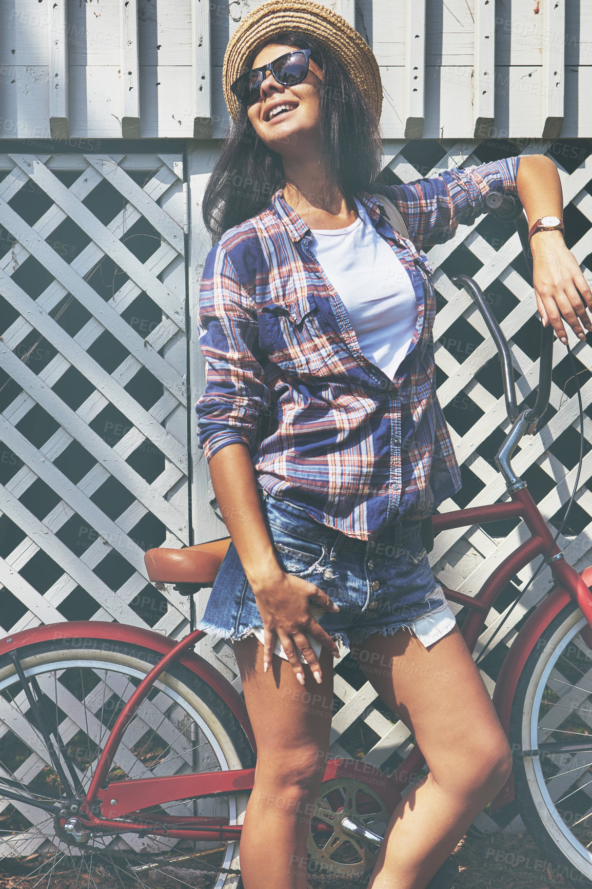 Buy stock photo Shot of a beautiful young woman riding her bike in the park