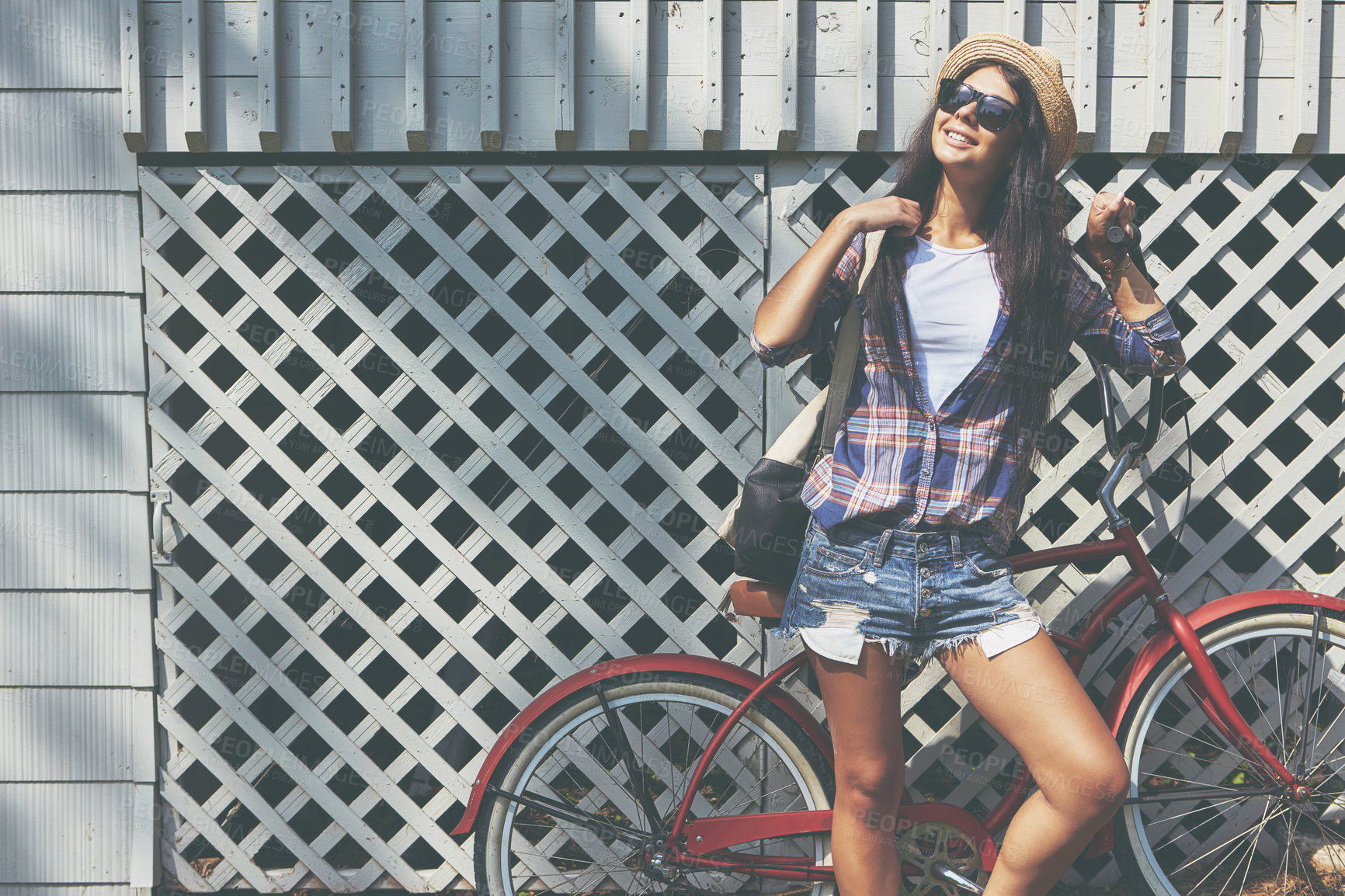 Buy stock photo Shot of a beautiful young woman riding her bike in the park