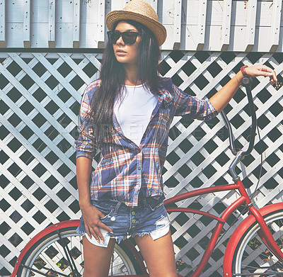 Buy stock photo Shot of a beautiful young woman riding her bike in the park