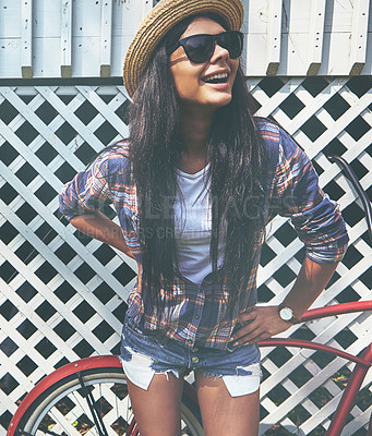 Buy stock photo Shot of a beautiful young woman riding her bike in the park