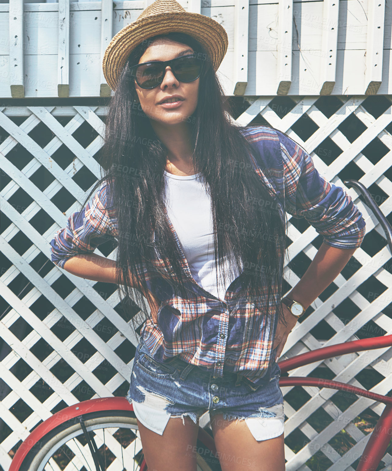 Buy stock photo Shot of a beautiful young woman riding her bike in the park