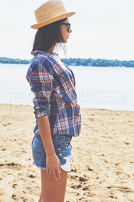 Buy stock photo Shot of an attractive young woman enjoying a day on the beach