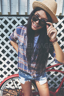 Buy stock photo Portrait of a beautiful young woman riding her bike in the park