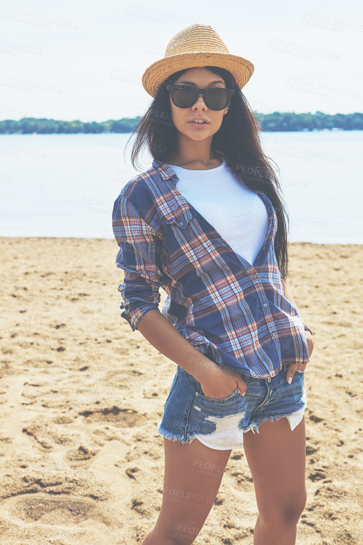 Buy stock photo Shot of an attractive young woman enjoying a day on the beach