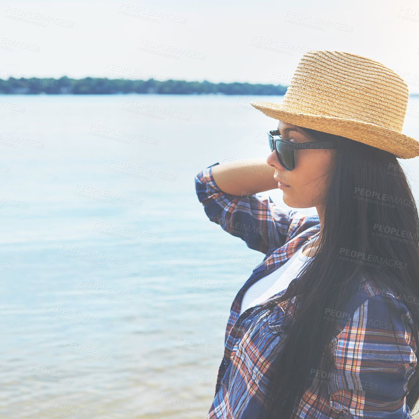 Buy stock photo Shot of an attractive young woman enjoying a day on the beach