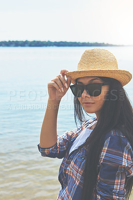 Buy stock photo Shot of an attractive young woman enjoying a day on the beach