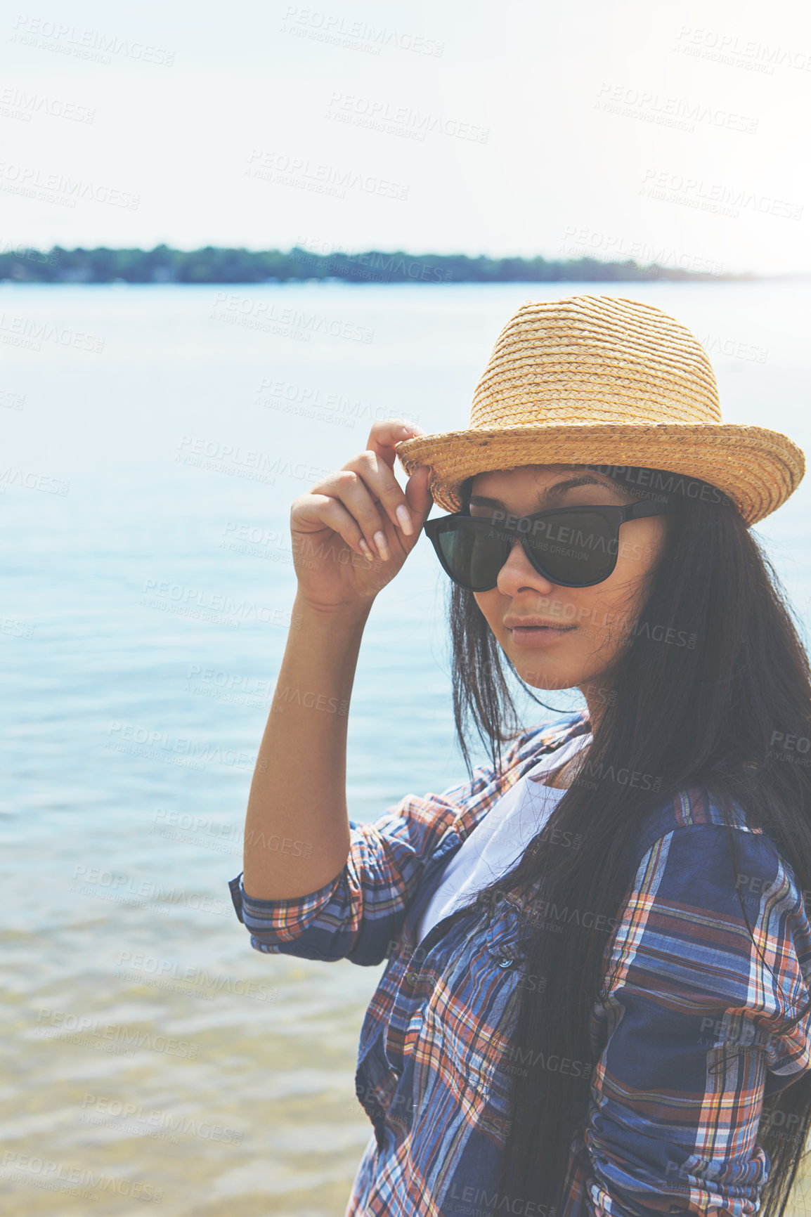 Buy stock photo Shot of an attractive young woman enjoying a day on the beach