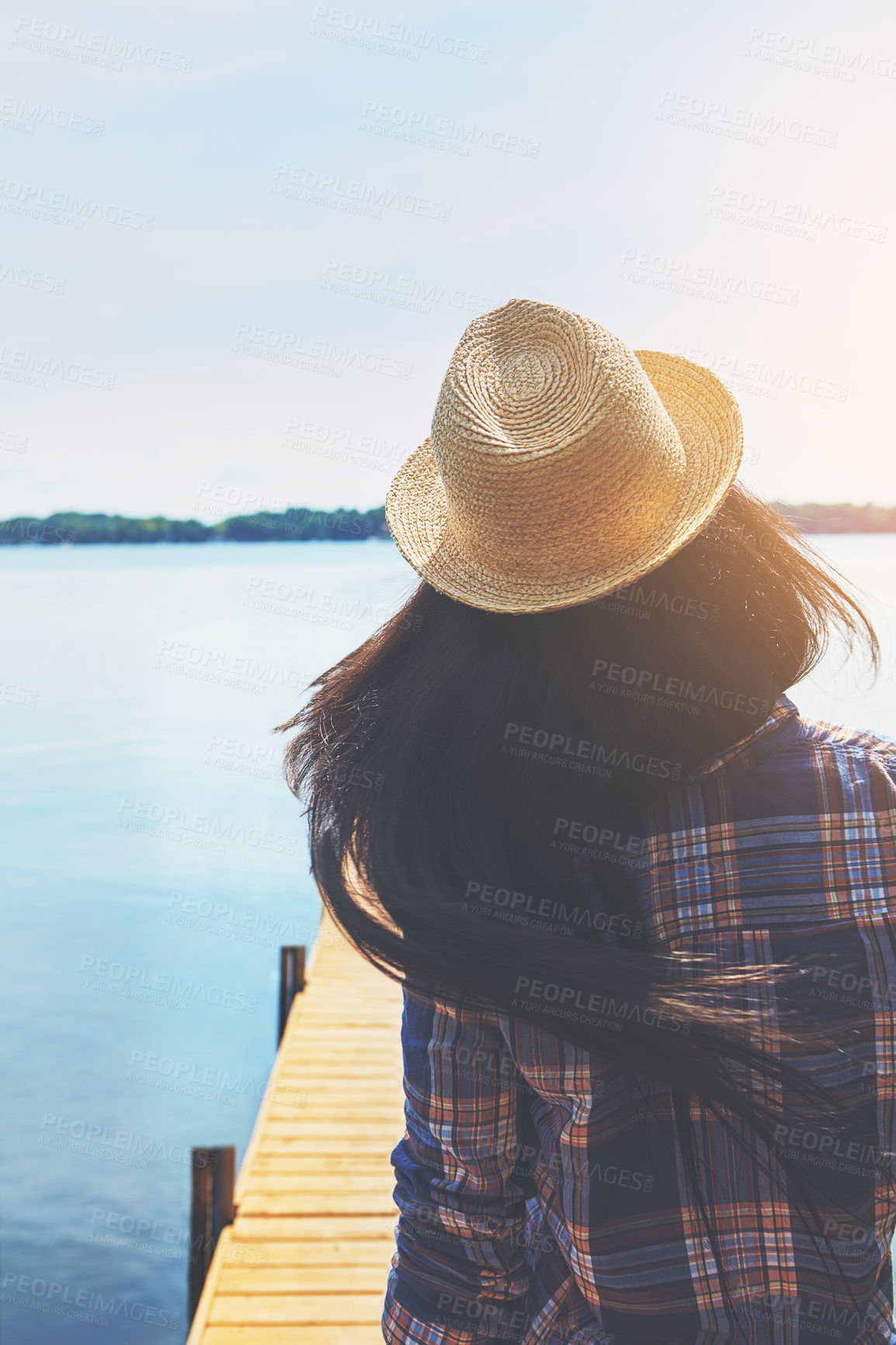 Buy stock photo Shot of an attractive young woman enjoying a day on the beach