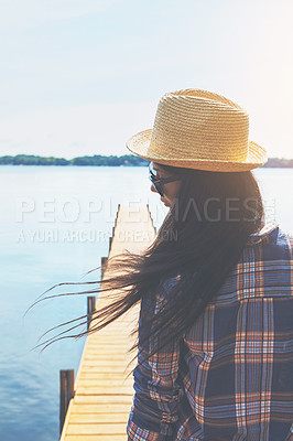 Buy stock photo Shot of an attractive young woman enjoying a day on the beach