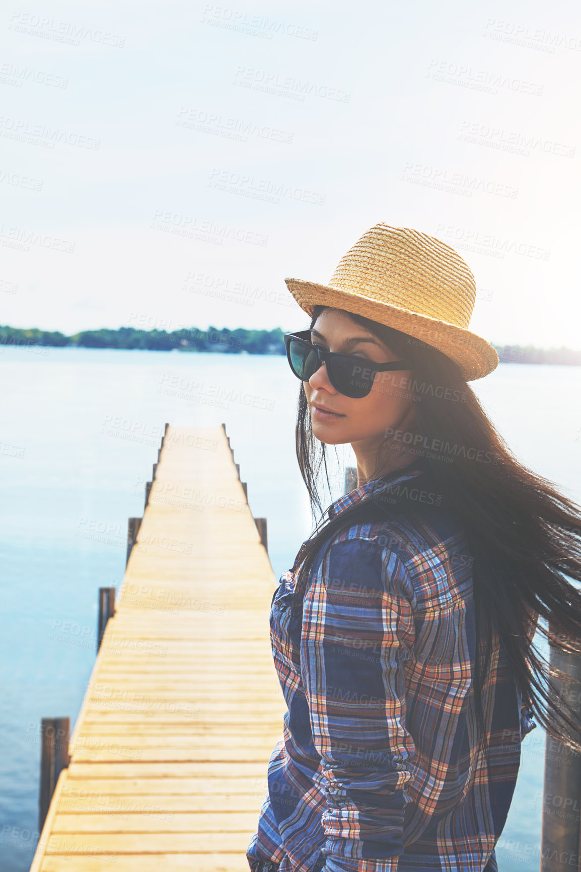 Buy stock photo Shot of an attractive young woman enjoying a day on the beach