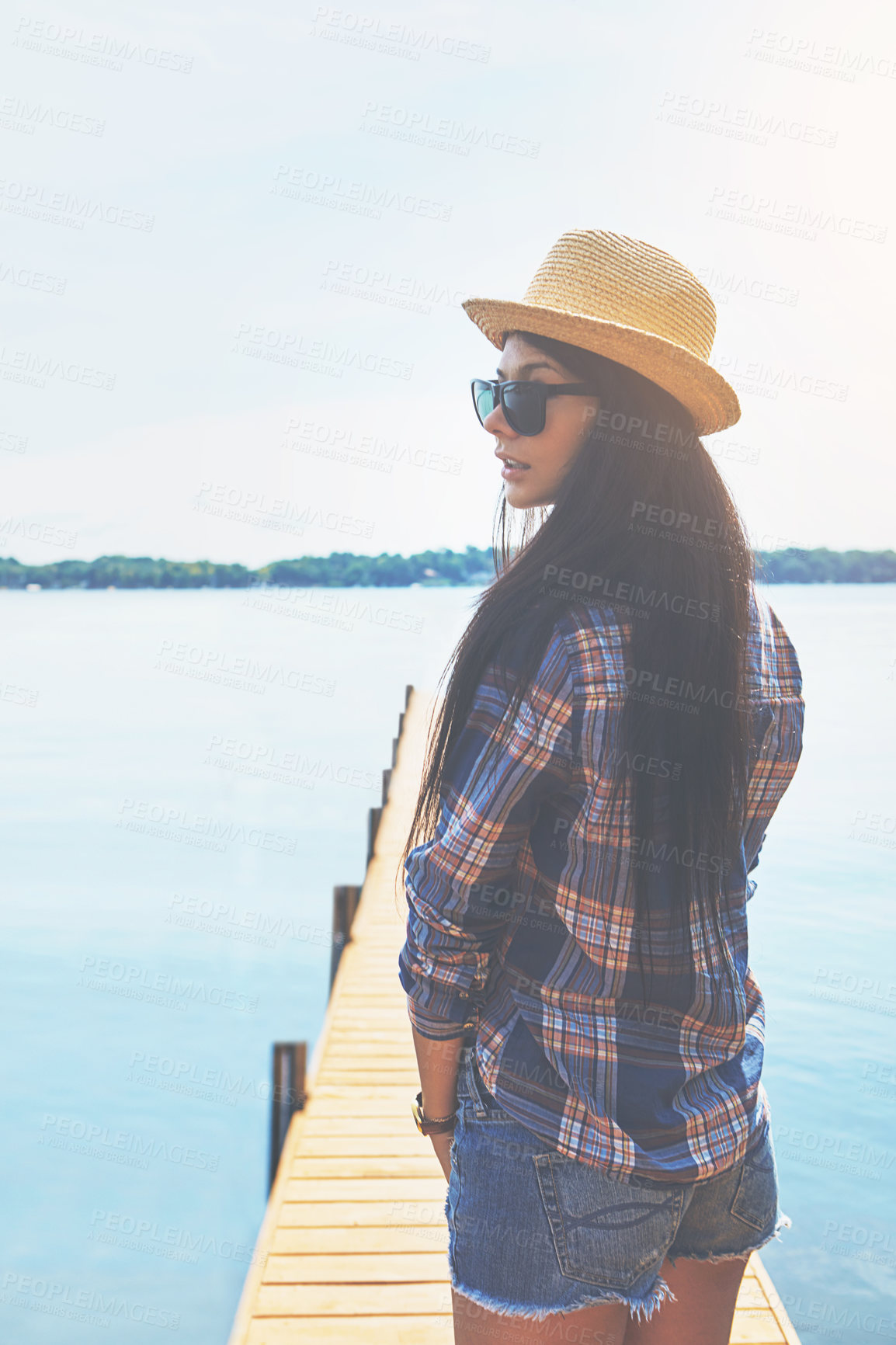 Buy stock photo Shot of an attractive young woman enjoying a day on the beach