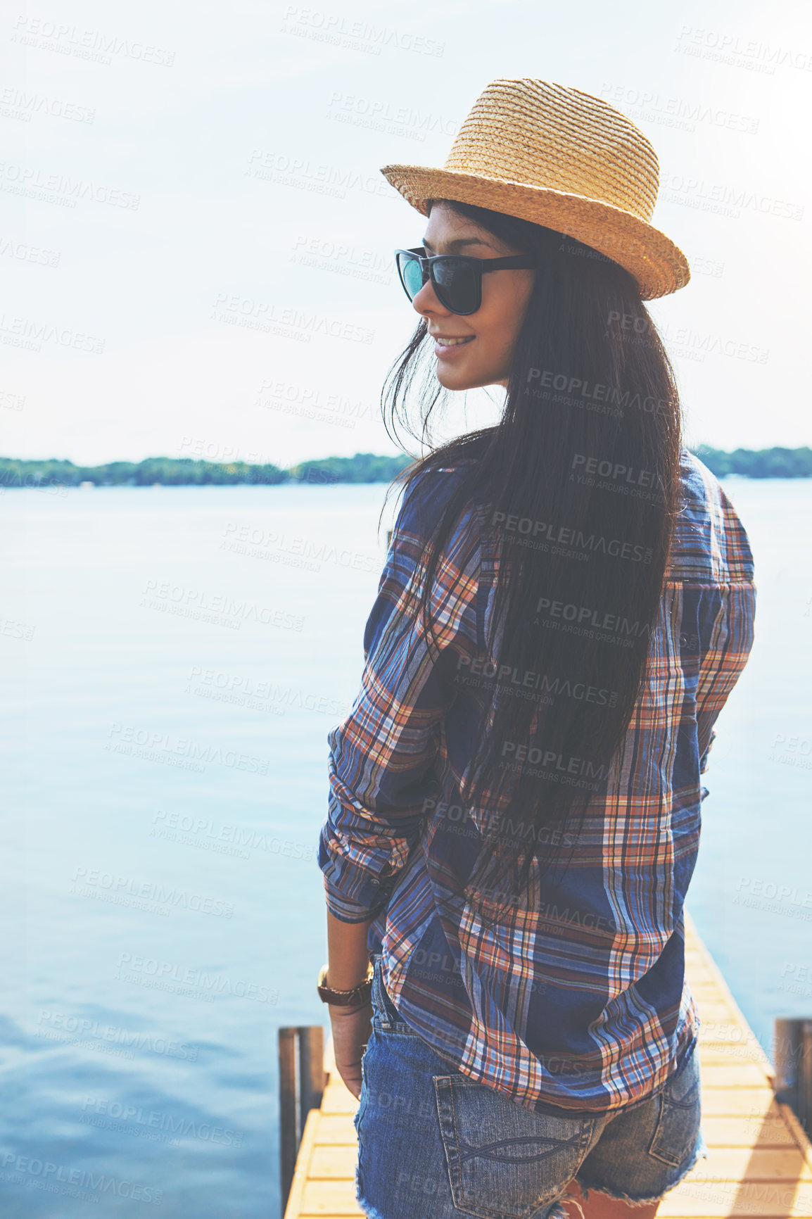 Buy stock photo Shot of an attractive young woman enjoying a day on the beach