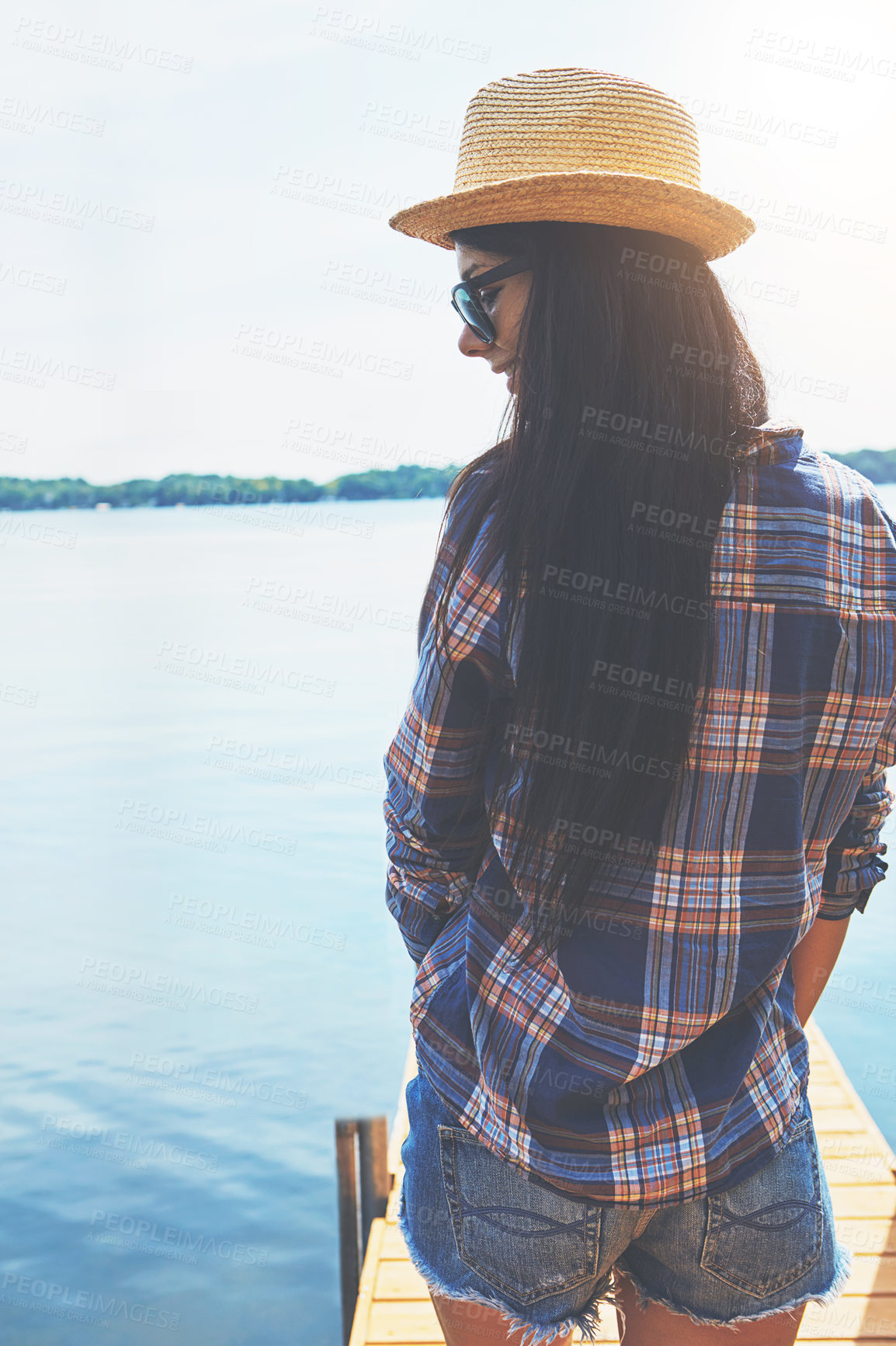 Buy stock photo Shot of an attractive young woman enjoying a day on the beach