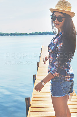 Buy stock photo Shot of an attractive young woman enjoying a day on the beach