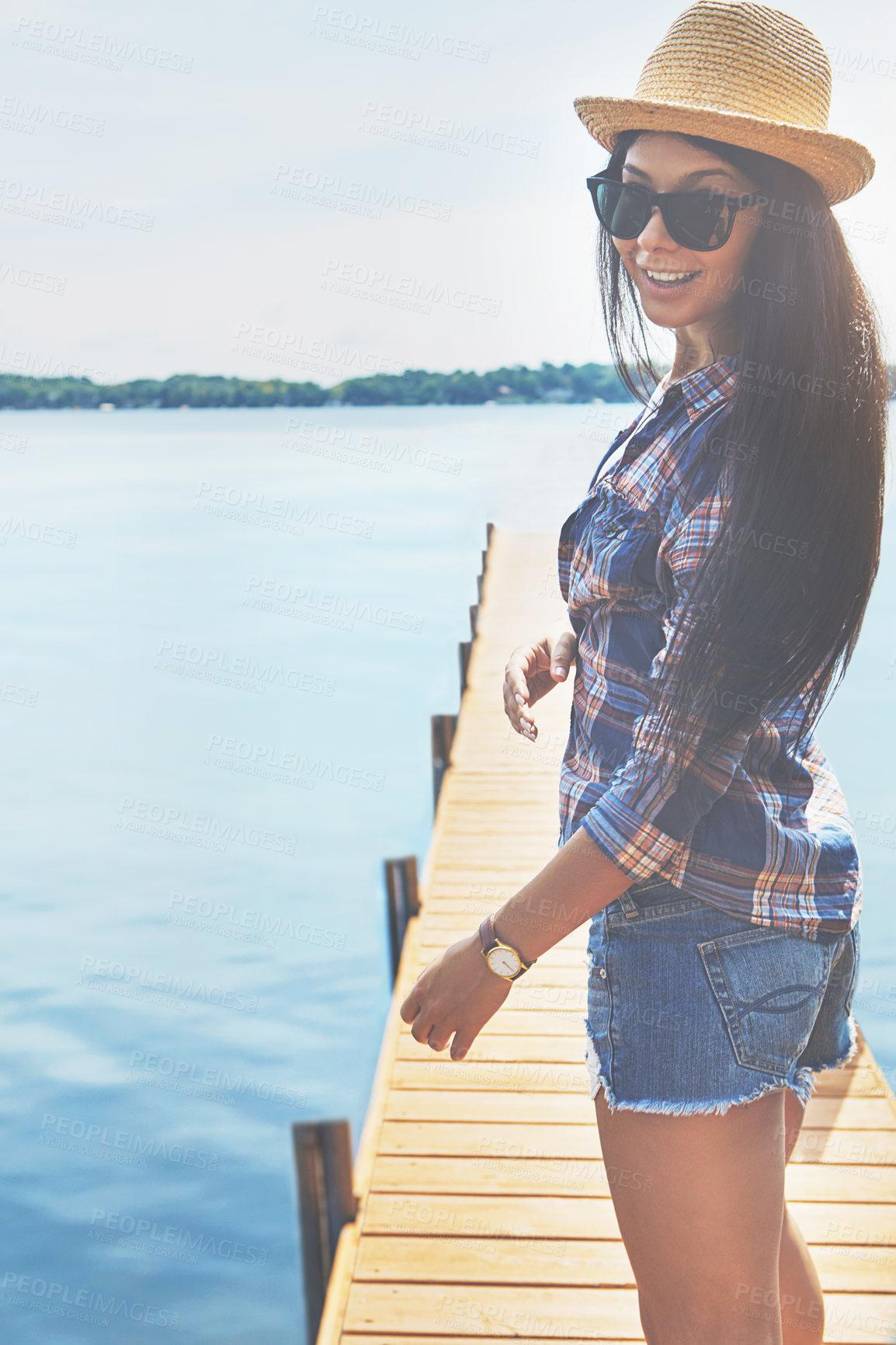 Buy stock photo Shot of an attractive young woman enjoying a day on the beach