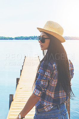 Buy stock photo Shot of an attractive young woman enjoying a day on the beach