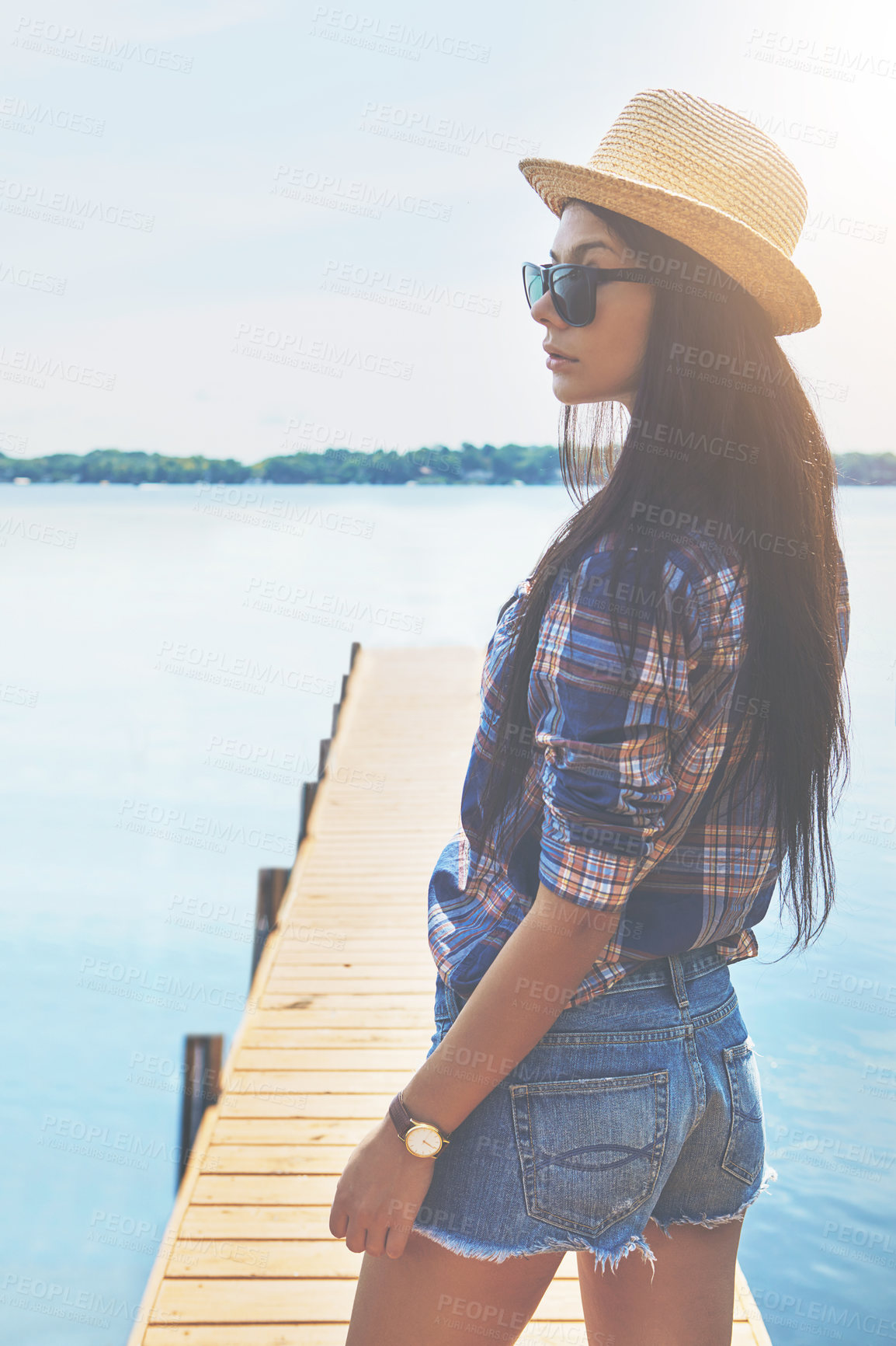 Buy stock photo Shot of an attractive young woman enjoying a day on the beach