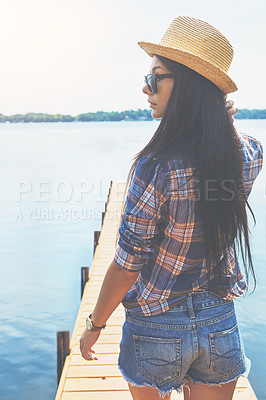 Buy stock photo Shot of an attractive young woman enjoying a day on the beach