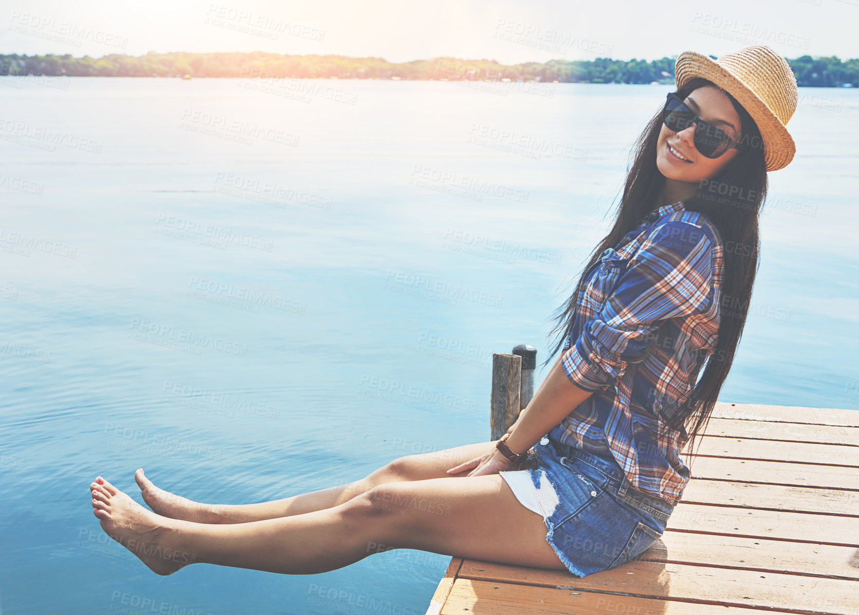 Buy stock photo Shot of an attractive young woman enjoying a day on the beach