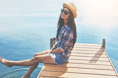 Buy stock photo Shot of an attractive young woman enjoying a day on the beach