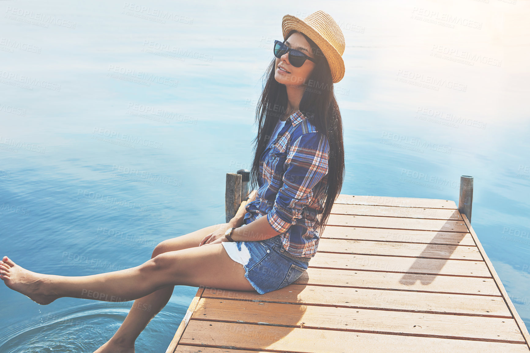 Buy stock photo Shot of an attractive young woman enjoying a day on the beach