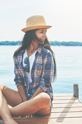 Buy stock photo Shot of an attractive young woman enjoying a day on the beach