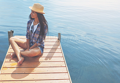 Buy stock photo Shot of an attractive young woman enjoying a day on the beach