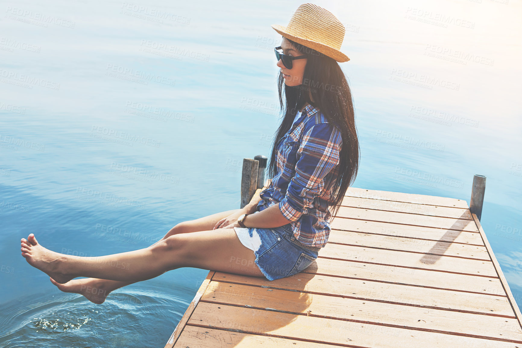 Buy stock photo Shot of an attractive young woman enjoying a day on the beach