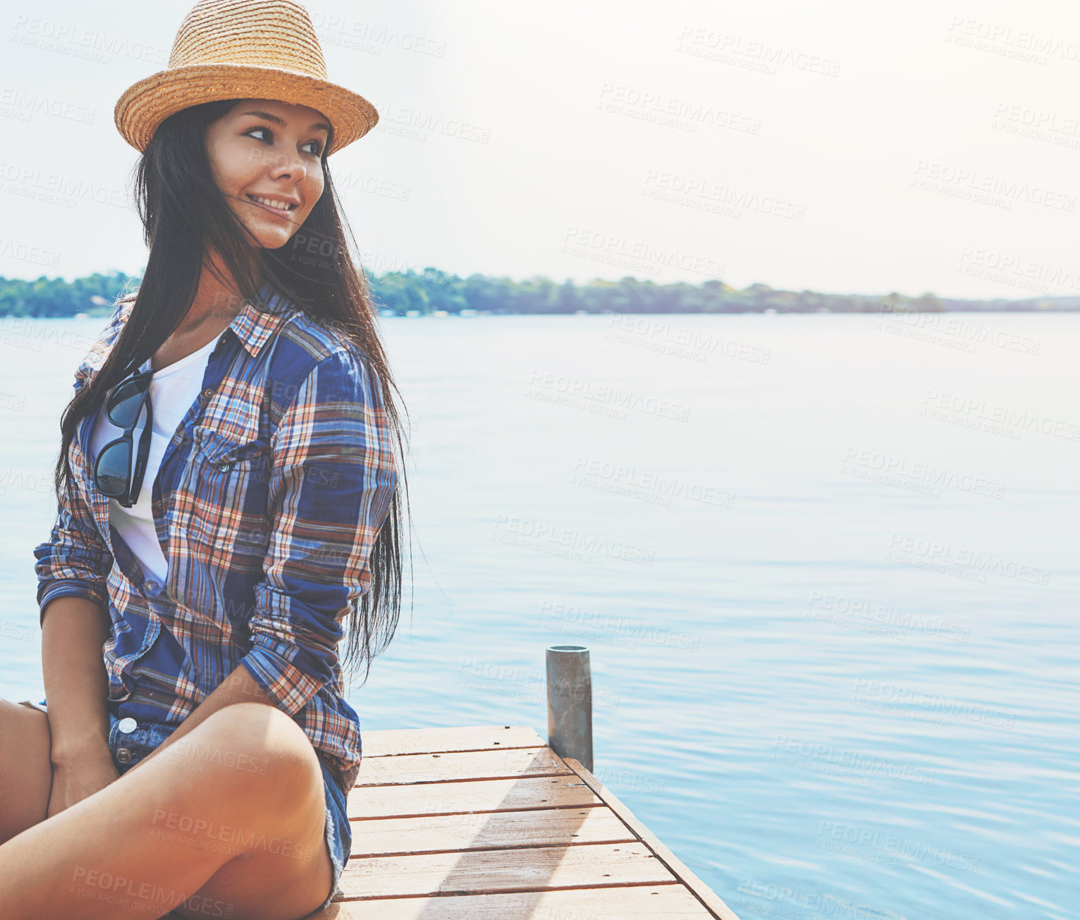 Buy stock photo Shot of an attractive young woman enjoying a day on the beach