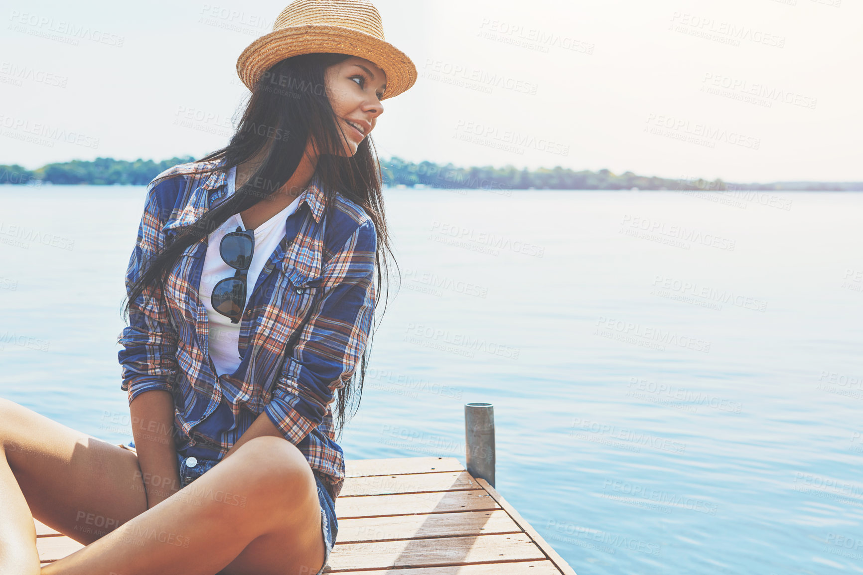 Buy stock photo Shot of an attractive young woman enjoying a day on the beach