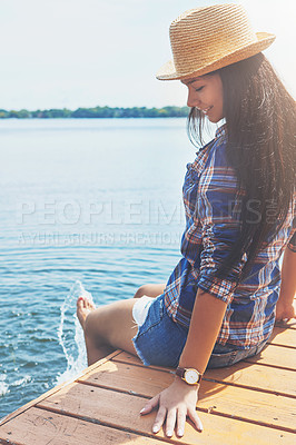 Buy stock photo Shot of an attractive young woman enjoying a day on the beach