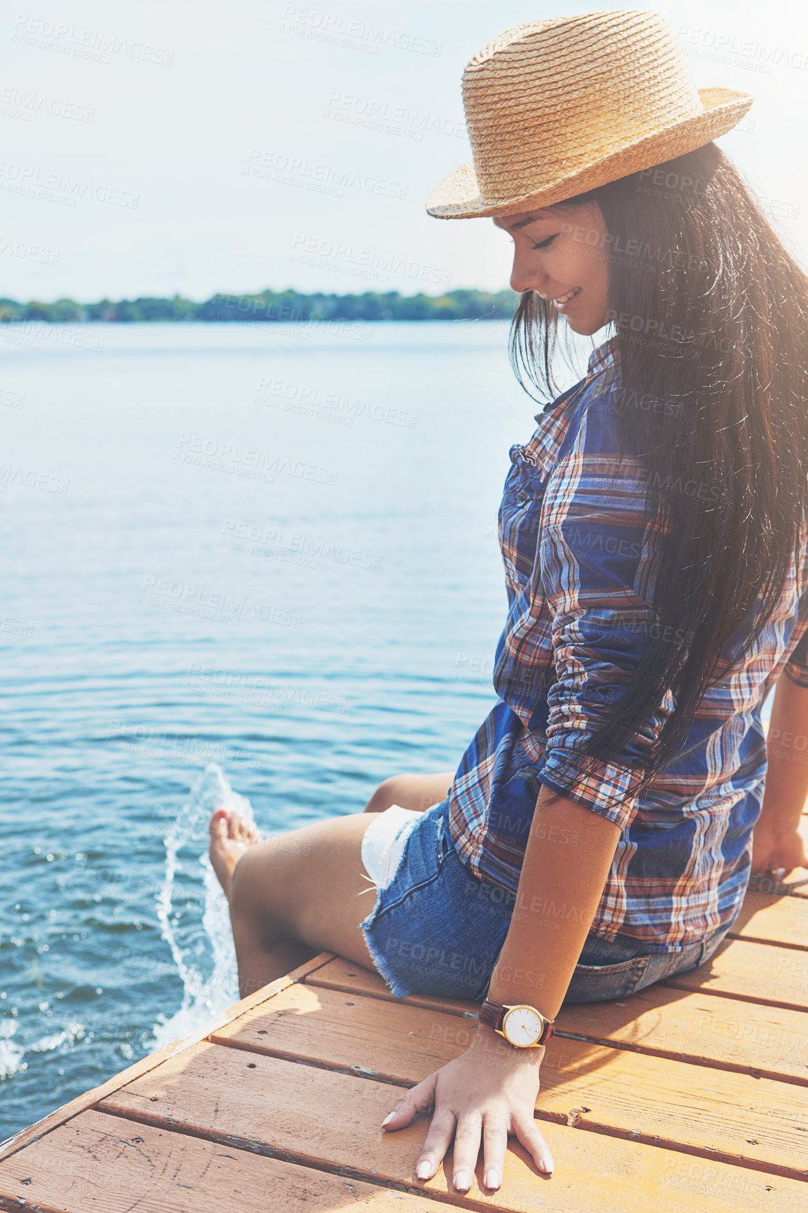 Buy stock photo Shot of an attractive young woman enjoying a day on the beach