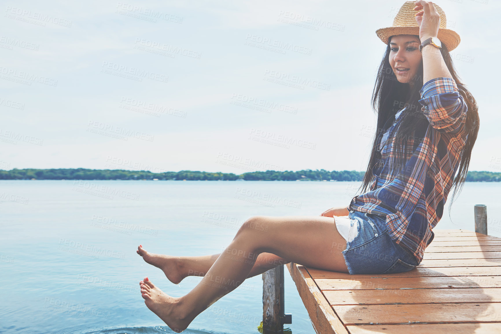 Buy stock photo Shot of an attractive young woman enjoying a day on the beach